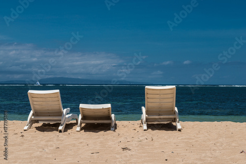 Summer time on beach and sunbed. Sunbeds on an empty beach in Bali © ronedya