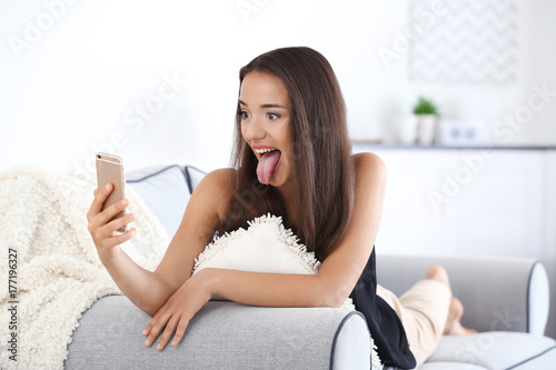 Beautiful young woman takin...