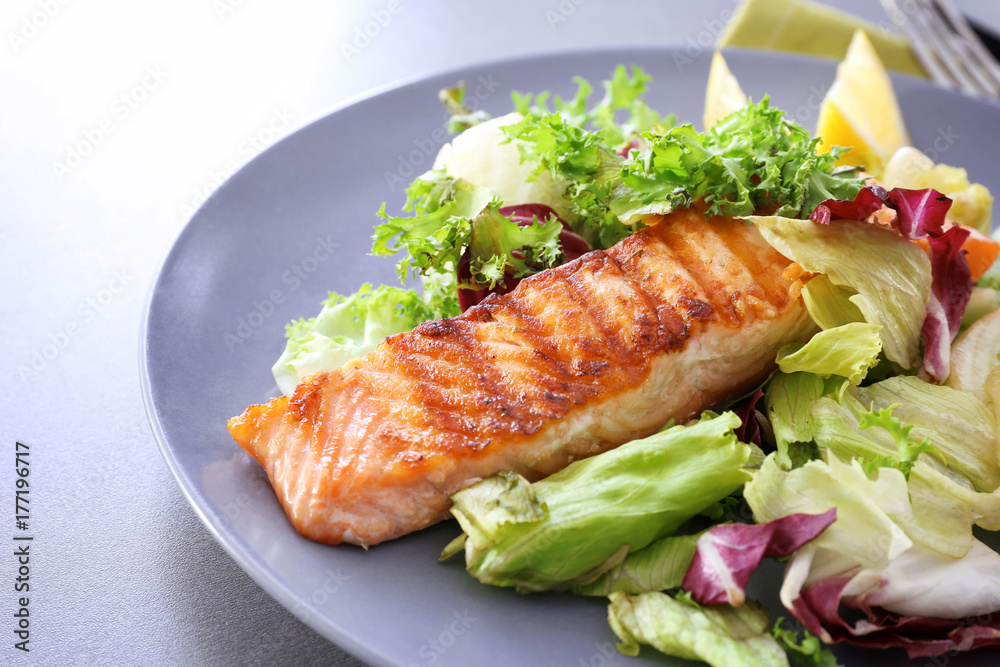 Slice of delicious salmon on plate, close up