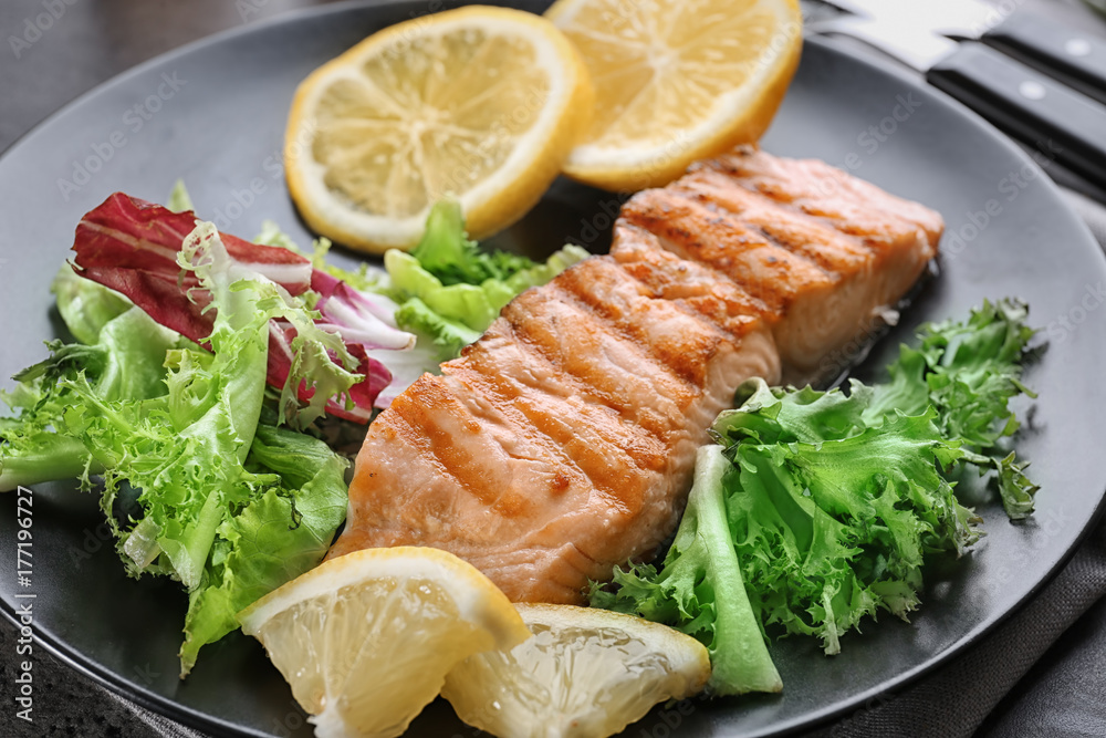 Slice of delicious salmon on plate, close up