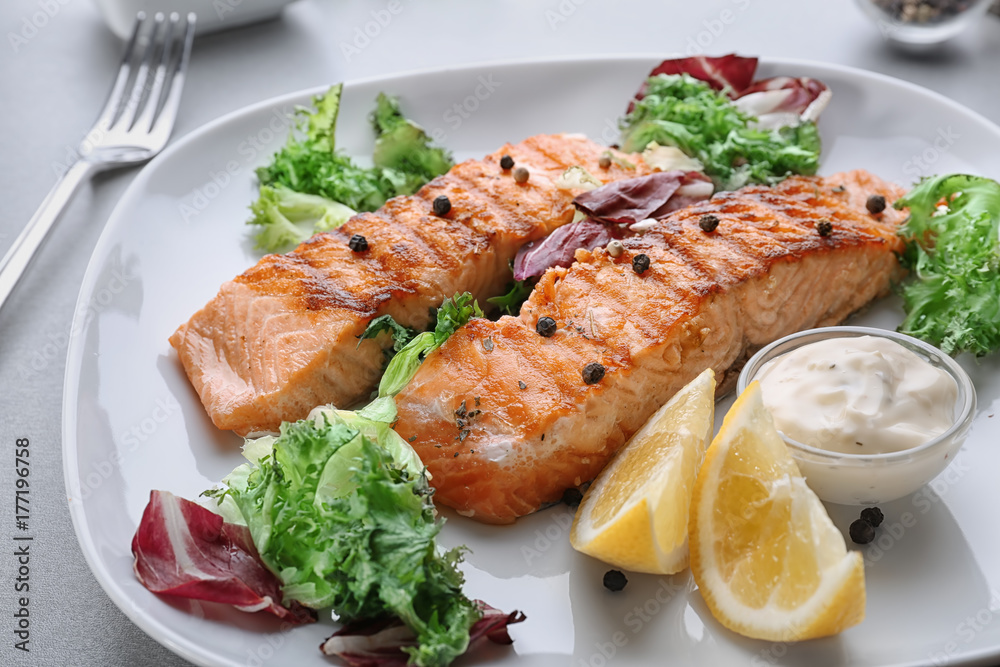 Delicious slices of salmon on plate, close up
