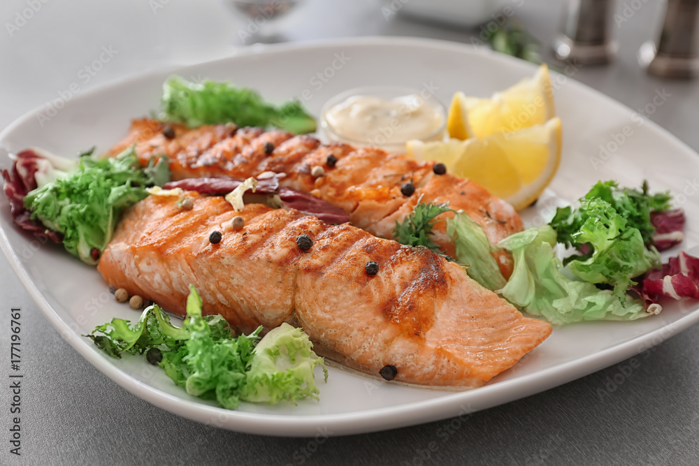 Delicious slices of salmon on plate, close up Delicious slices of salmon on plate, close up
