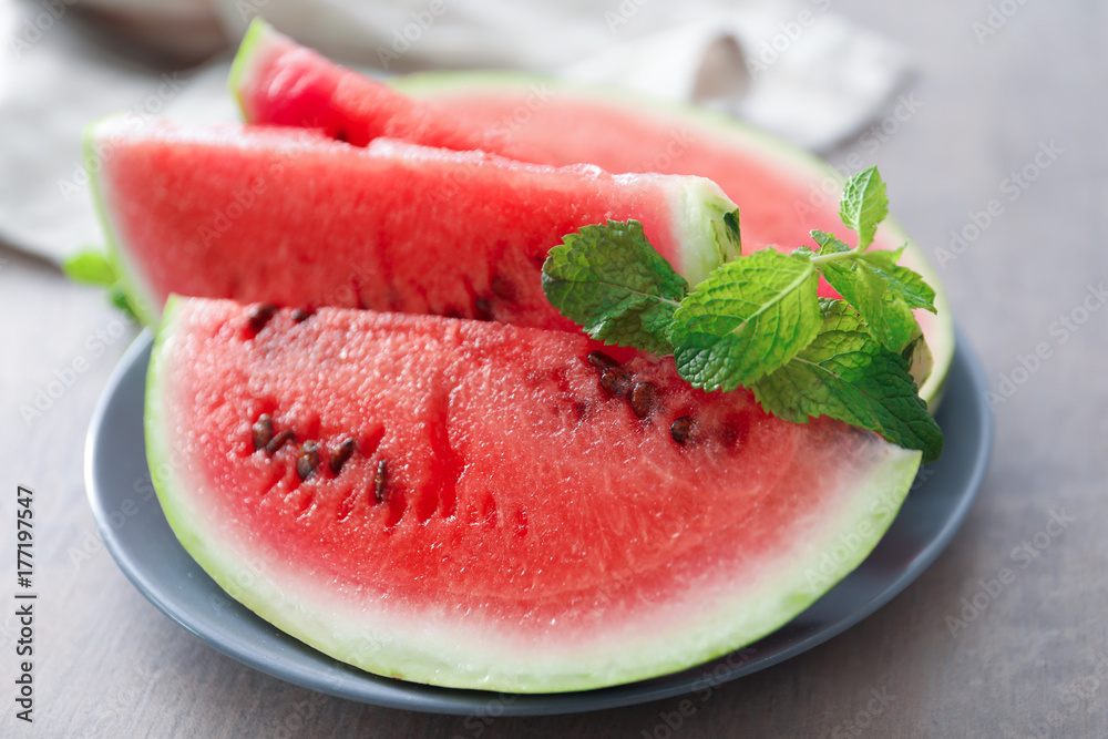 Plate with tasty sliced watermelon on table Plate with tasty sliced watermelon on table