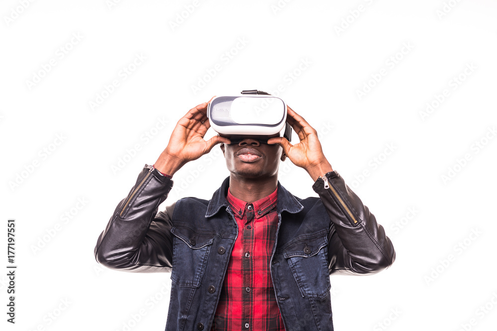 African American young man wearing vr virtual reality headset over white background African American young man wearing vr virtual reality headset over white background