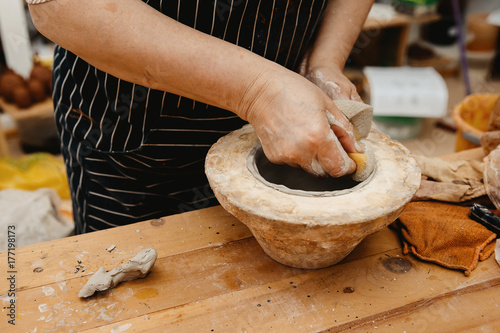 Ceramics. Master sculpts makes a plate according to the mold