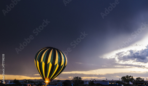 Hot air balloon glows in a stormy weather photo