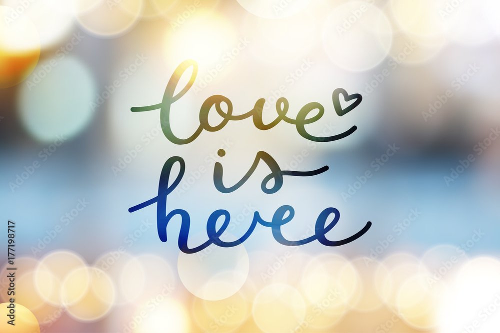 © redcollegiya - love is here lettering, vector handwritten text on blurred lights © redcollegiya - love is here lettering, vector handwritten text on blurred lights