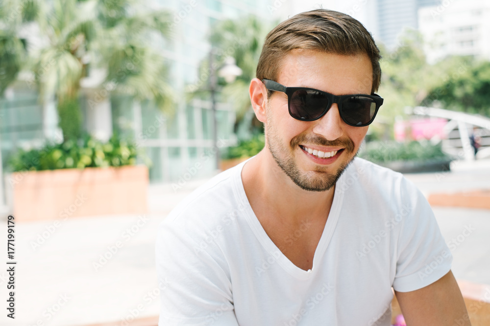 Portrait of a smiling young man with sunglasses Portrait of a smiling young man with sunglasses