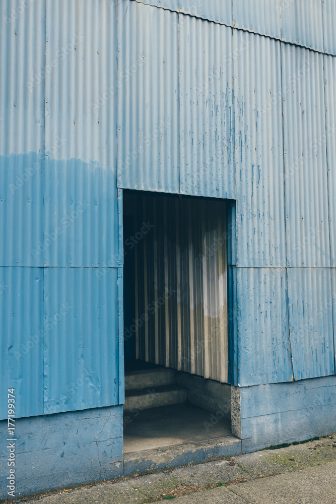 Doorway leading into old, painted warehouse Doorway leading into old, painted warehouse