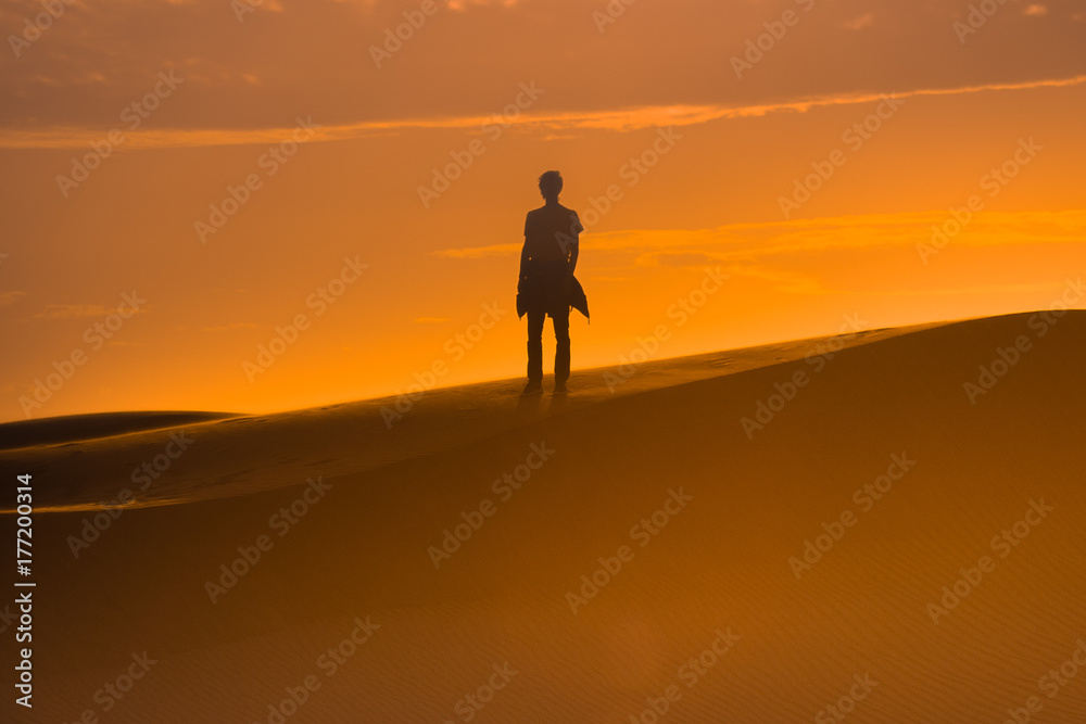 Two human silhouette in the sand desert 