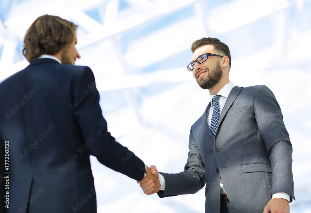 Business handshake and business people. Business handshake and business people.