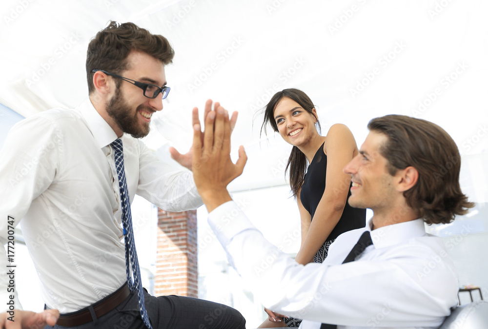business colleagues giving each other high five. business colleagues giving each other high five.