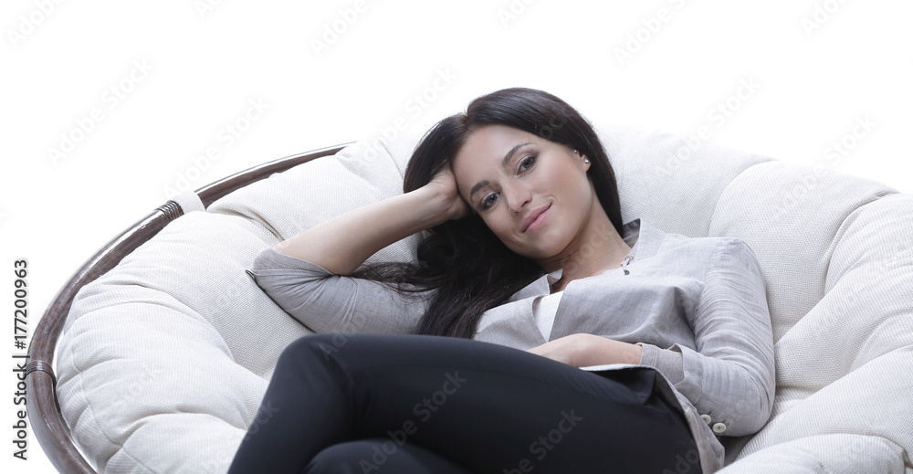 young woman sitting in a comfortable soft big armchair young woman sitting in a comfortable soft big armchair