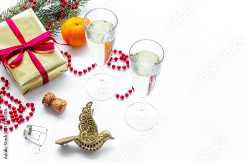 new year 2018 design with gift box, tangerine, spruce branch, champagne in glasses white background space for text