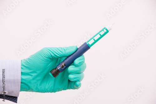doctor hand holding medical tool,insulin pen