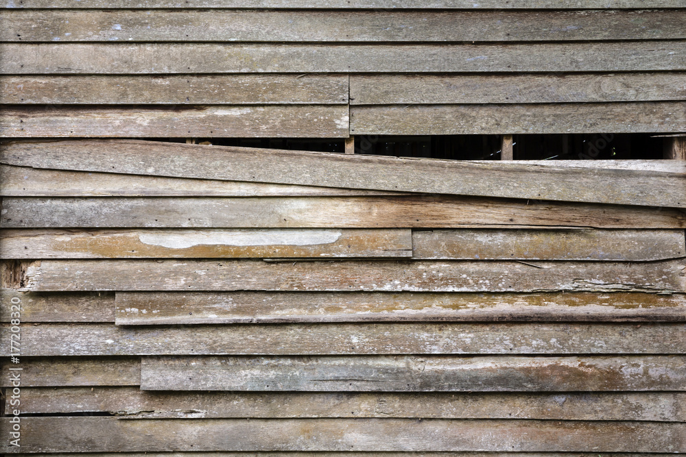 the-old-wooden-wall-house-is-ruined-and-one-piece-of-old-wood-is