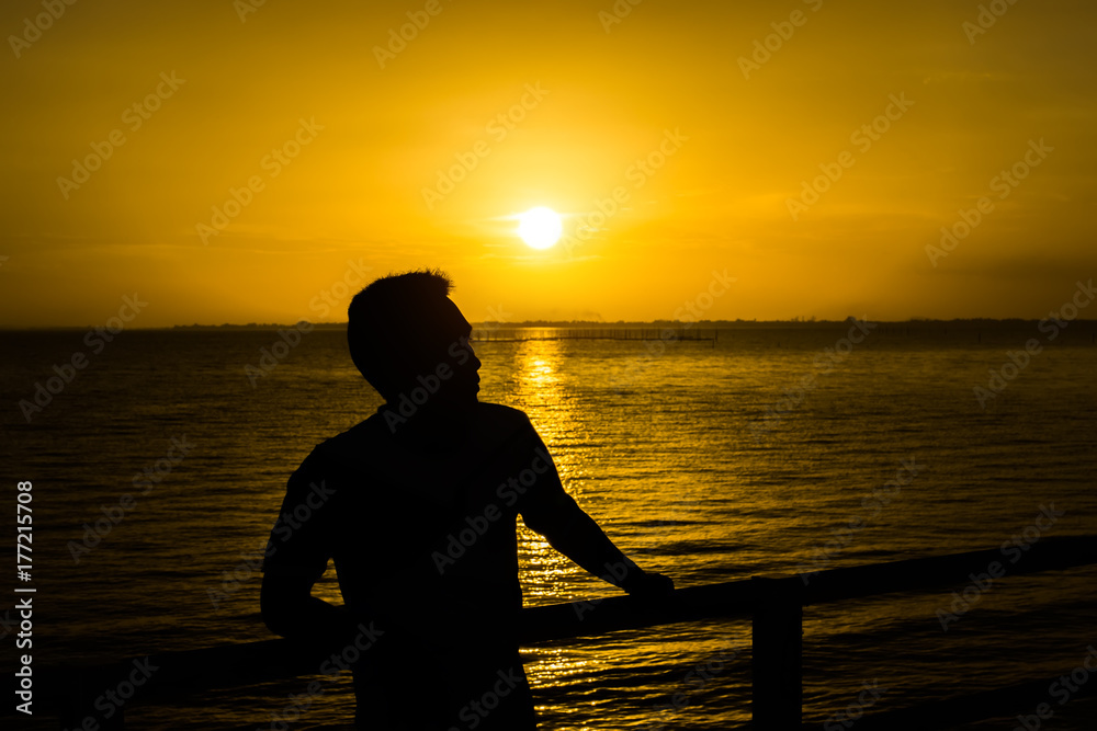 Silhouette of a lonely man at sunset