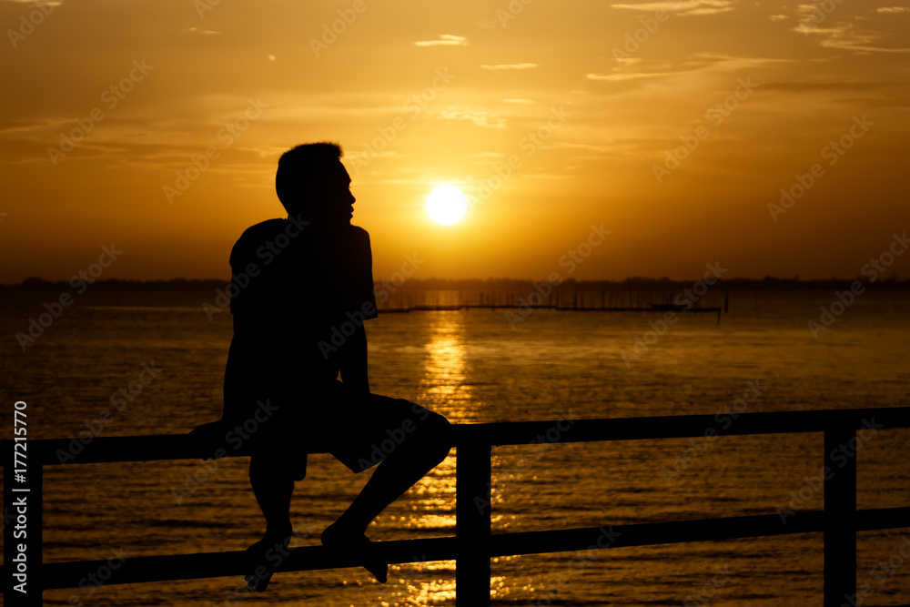 Fototapeta premium Silhouette of a lonely man at sunset