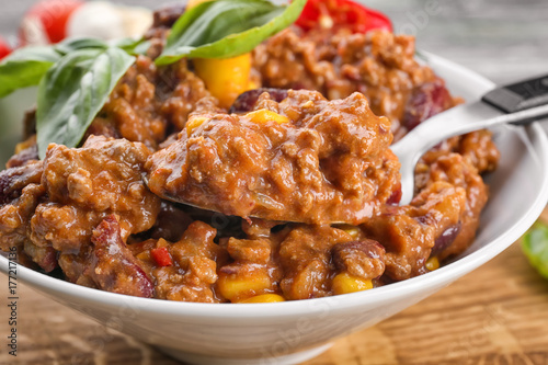 Plate with chili con carne on table, closeup