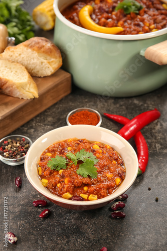 Bowl with delicious chili con carne on table