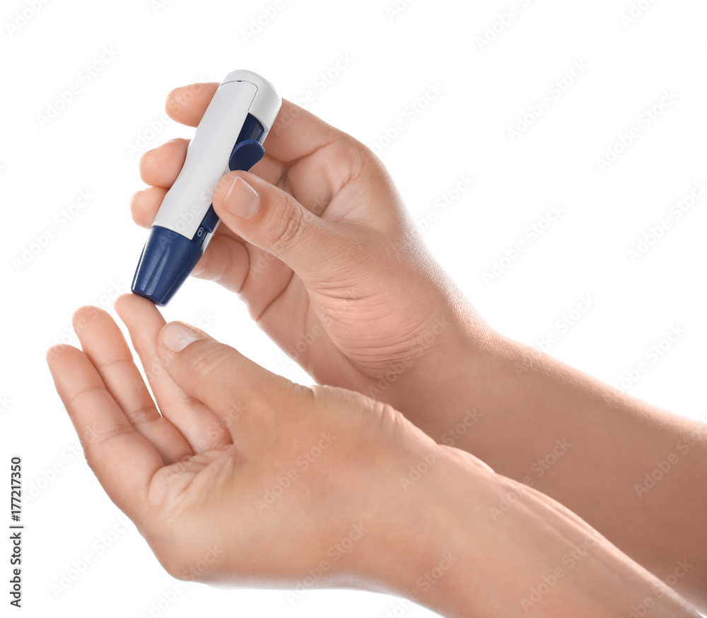 Woman taking blood sample with lancet pen on white background. Diabetes concept Woman taking blood sample with lancet pen on white background. Diabetes concept