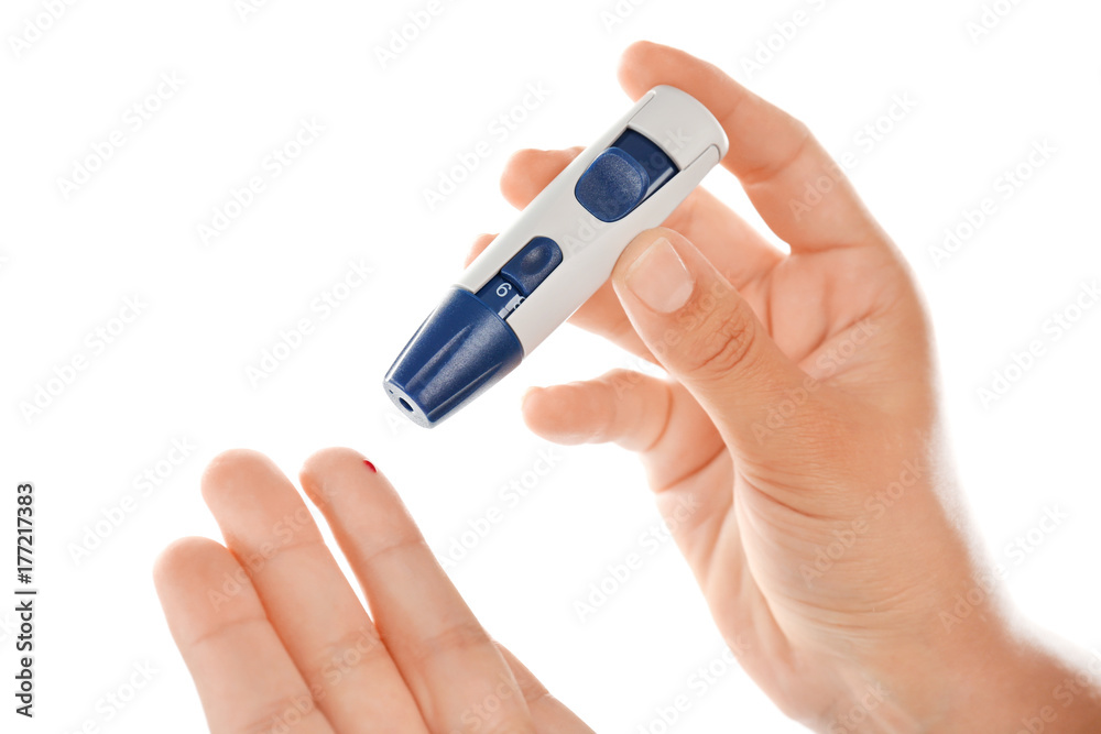 Woman taking blood sample with lancet pen on white background. Diabetes concept Woman taking blood sample with lancet pen on white background. Diabetes concept