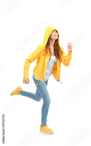 Young woman running on whit...