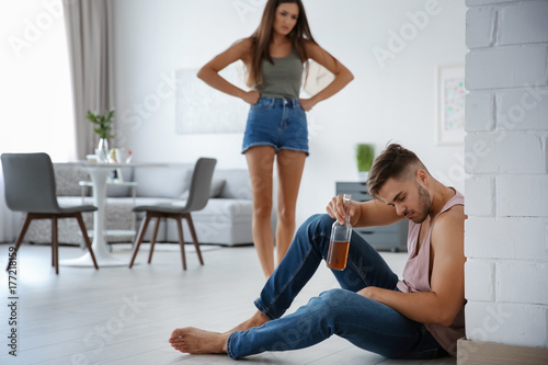 Принти на полотні Angry young woman and drunk man at home