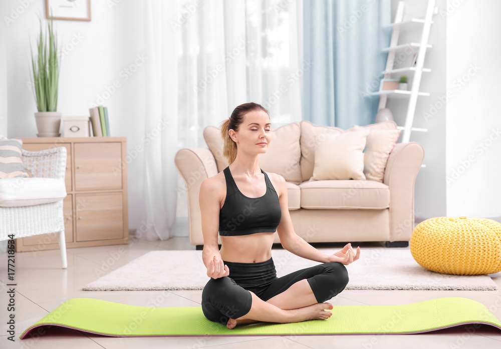 Young beautiful woman training at home Young beautiful woman training at home