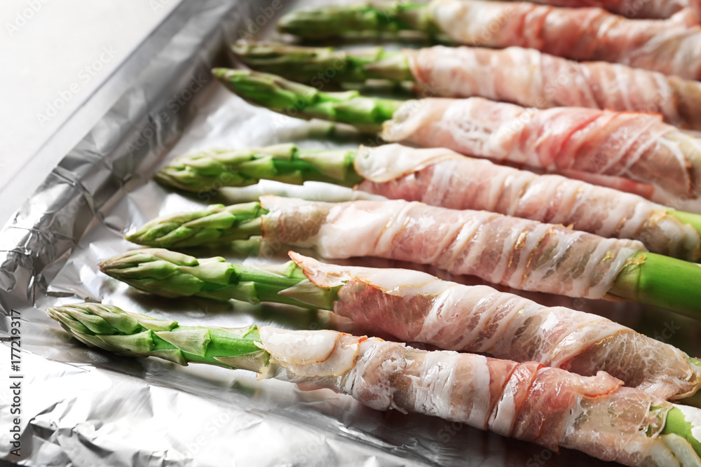 Plate with bacon wrapped asparagus on light background Plate with bacon wrapped asparagus on light background