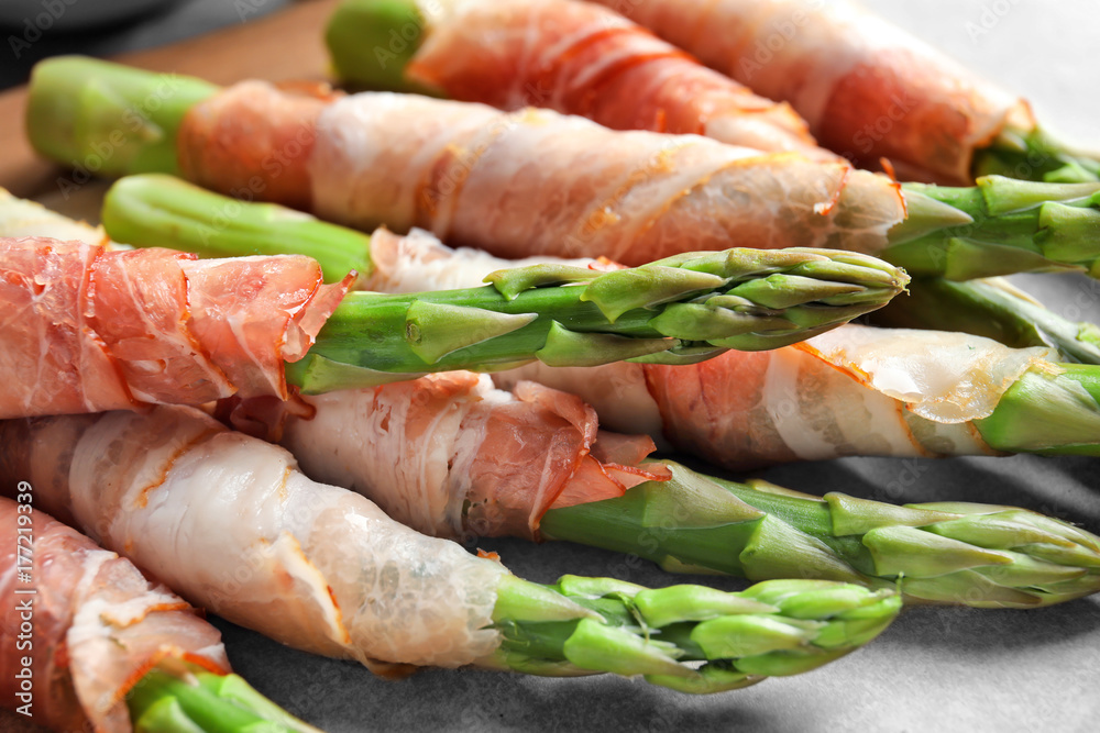 Plate with bacon wrapped asparagus on light background Plate with bacon wrapped asparagus on light background