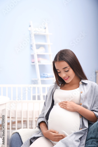 Pregnant woman sitting in b...