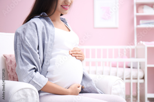 Pregnant woman sitting in b...