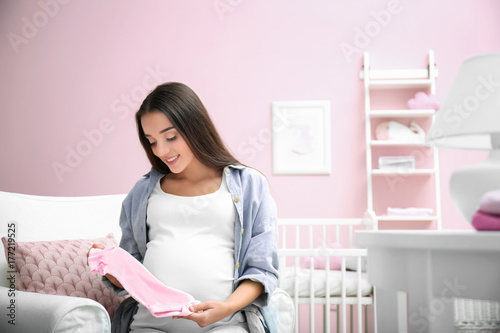 Pregnant woman holding baby...