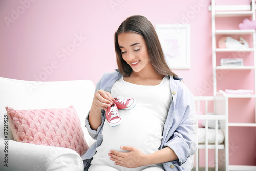 Pregnant woman holding baby...