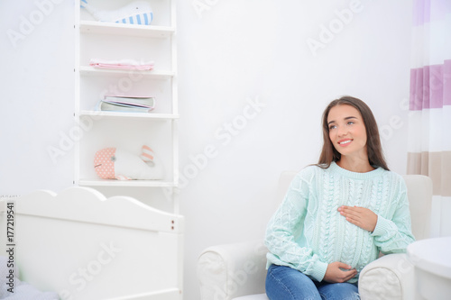 Pregnant woman sitting in b...