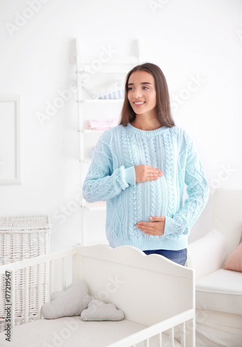 Pregnant woman standing nea...
