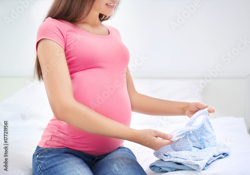 Pregnant woman holding baby...