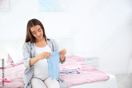 Pregnant woman holding baby...