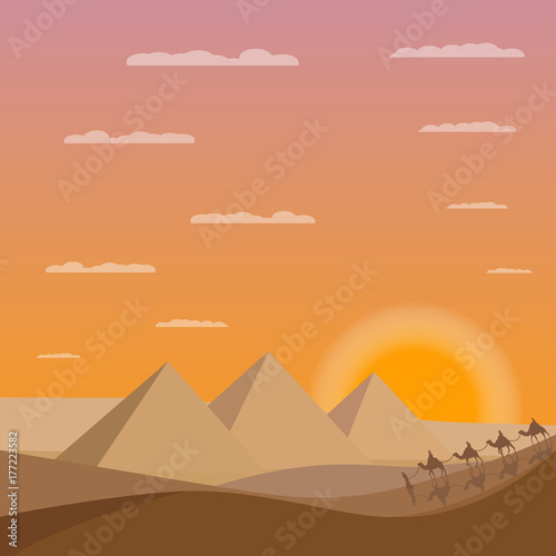 Caravan of camels near Egypt pyramids. Egypt sands with pyramids and sunset
