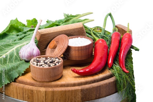 a set of spices of pepper, salt and herbs on a wooden surface