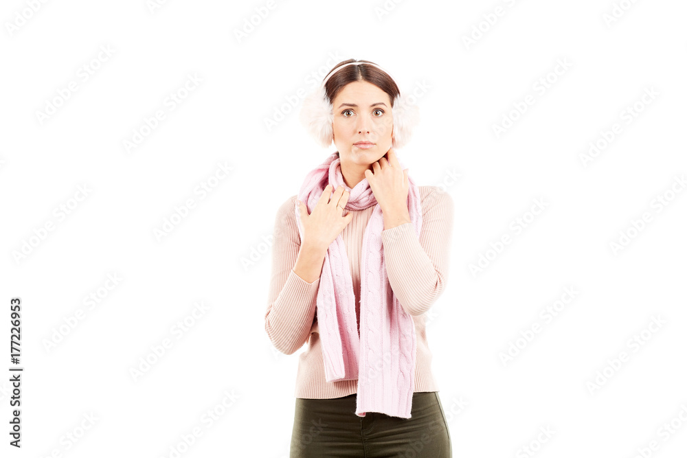 Portrait of young woman wearing winter earmuffs and scarf Portrait of young woman wearing winter earmuffs and scarf