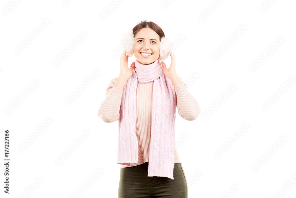 Portrait of young woman wearing winter earmuffs and scarf Portrait of young woman wearing winter earmuffs and scarf