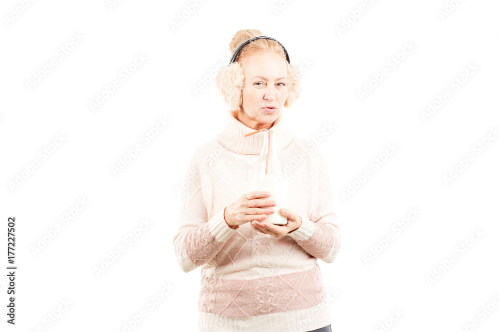 Portrait of senior woman wearing sweater and earmuffs Portrait of senior woman wearing sweater and earmuffs