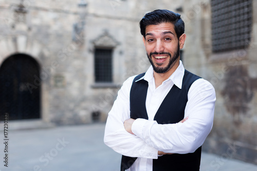 Smiling man keeping arms crossed