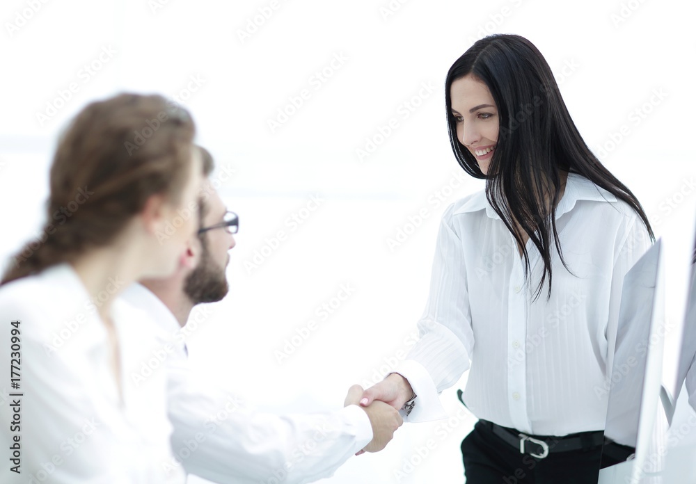 young business woman shaking hands with a colleague young business woman shaking hands with a colleague
