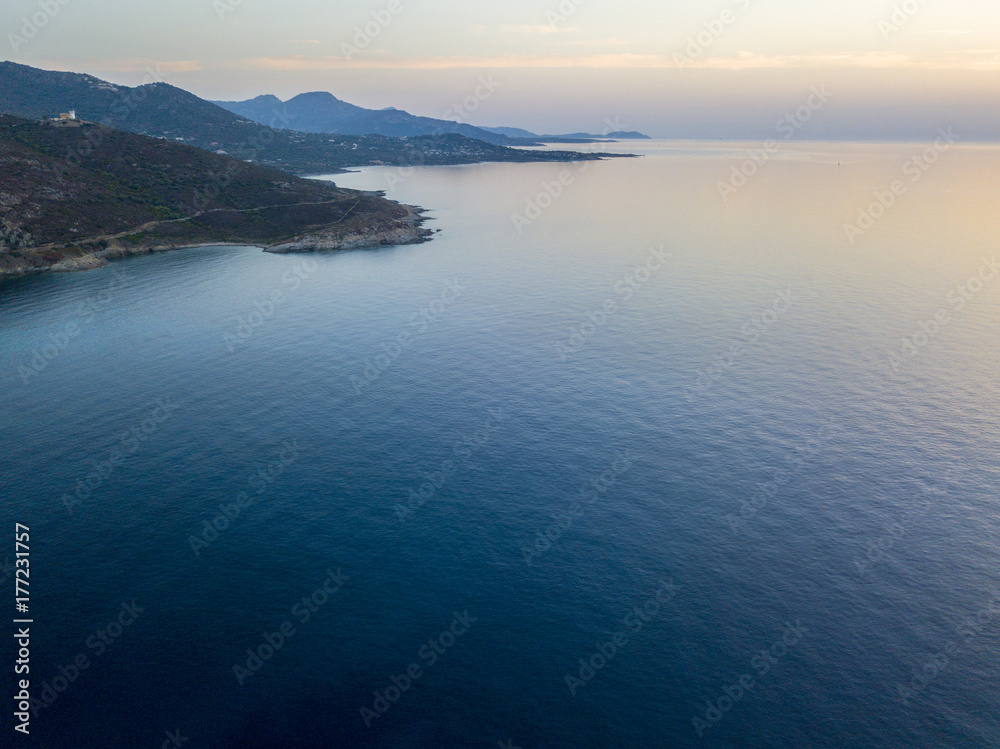 Fototapeta premium Vista aerea della costa della Corsica al tramonto, promontori che costeggiano il mare. Francia