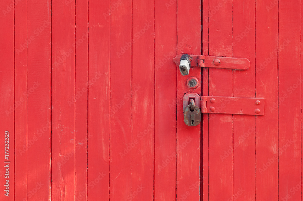 Metal lock and red wooden plank