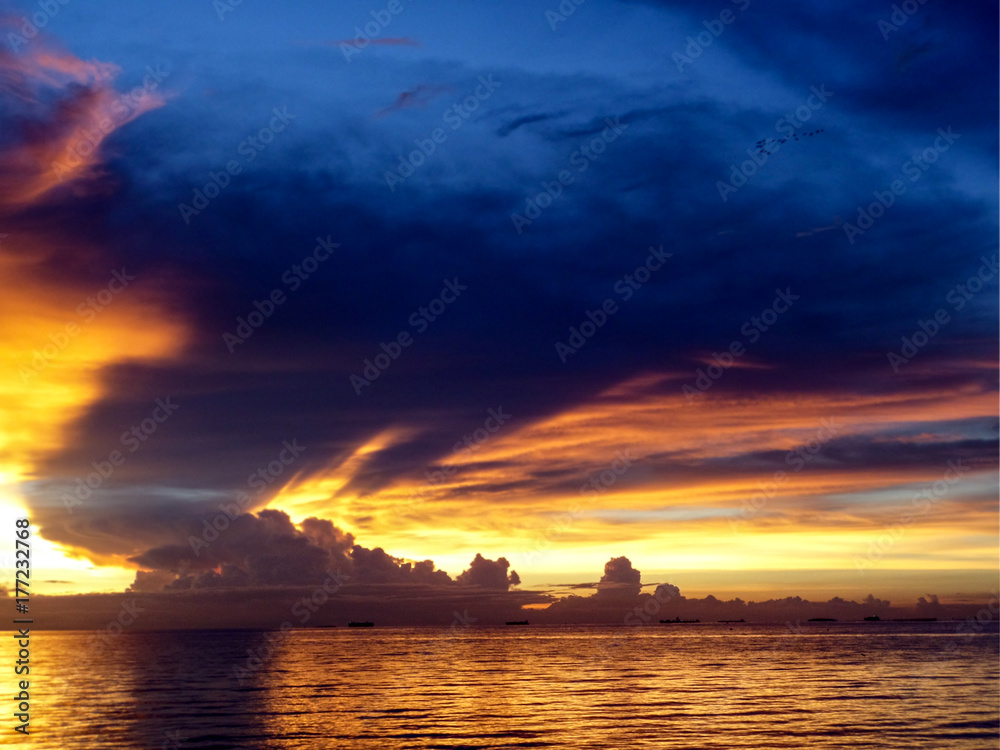 sunset sea ship on horizon line and  night cloud