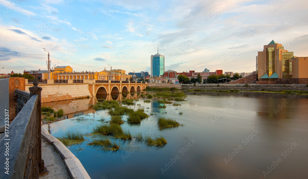 Fototapeta premium Troitsky bridge on Miass river in the evening, Chelyabinsk, Russia